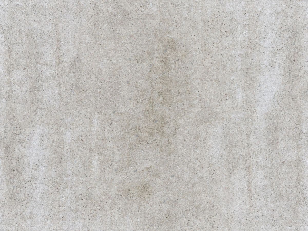 Close-up texture of a dense, freshly compacted roller-compacted concrete surface.